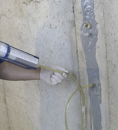 technicians repairing foundation wall